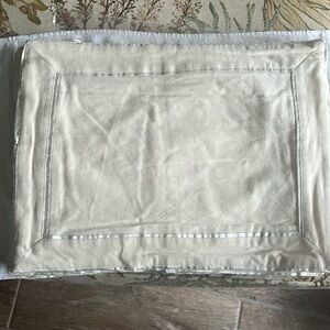 Four cotton/Linen placemats. Sand color with silver border.